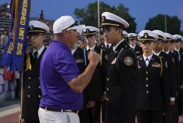 Brady Holaday congratulates LHS NJ ROTC Commander Aaron Dorfmeier prior to Friday night's football game.